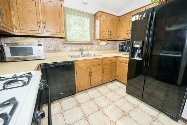 4 Wedgewood Road Matteson, IL 60443 - Photo 8 of 20 a kitchen with stainless steel appliances granite countertop a sink stove and refrigerator