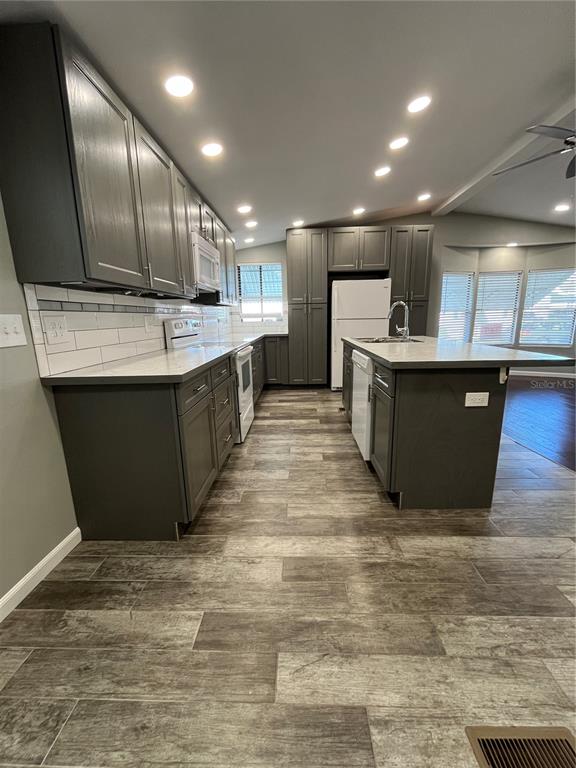 12100 Seminole Boulevard, Unit 365 Largo, FL 33778 - Photo 14 of 32 a large kitchen with kitchen island a sink wooden cabinets and stainless steel appliances