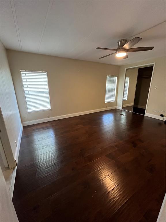 12100 Seminole Boulevard, Unit 365 Largo, FL 33778 - Photo 15 of 32 a view of empty room with wooden floor and fan