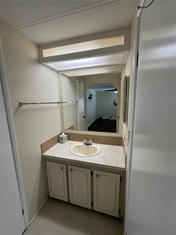 a bathroom with a granite countertop sink and mirror