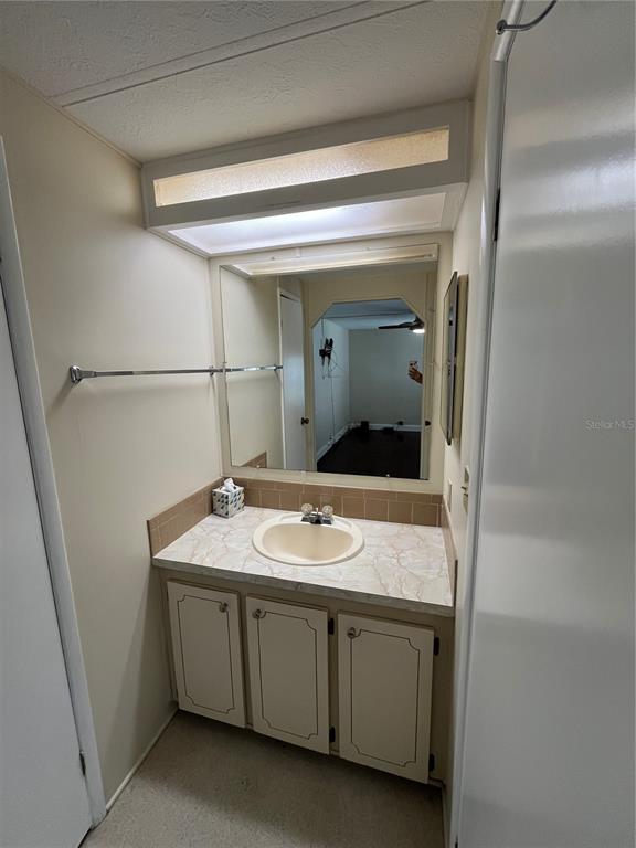 12100 Seminole Boulevard, Unit 365 Largo, FL 33778 - Photo 17 of 32 a bathroom with a granite countertop sink and mirror