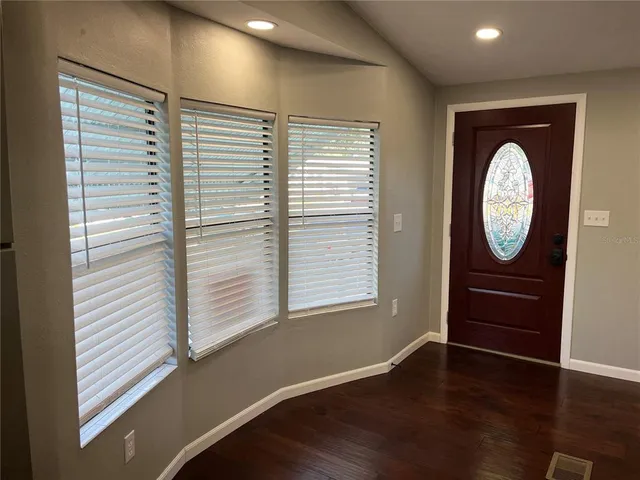 a view of a hallway with wooden floor