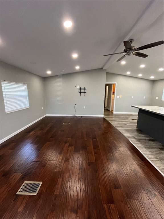 12100 Seminole Boulevard, Unit 365 Largo, FL 33778 - Photo 7 of 32 an empty room with wooden floor and windows
