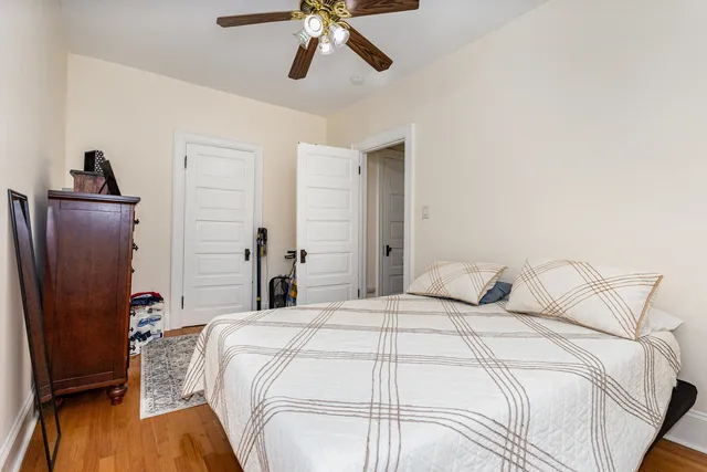 a bedroom with a bed and wooden floor