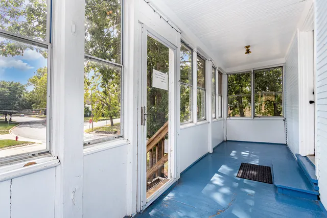 a view of an entryway with wooden floor and windows