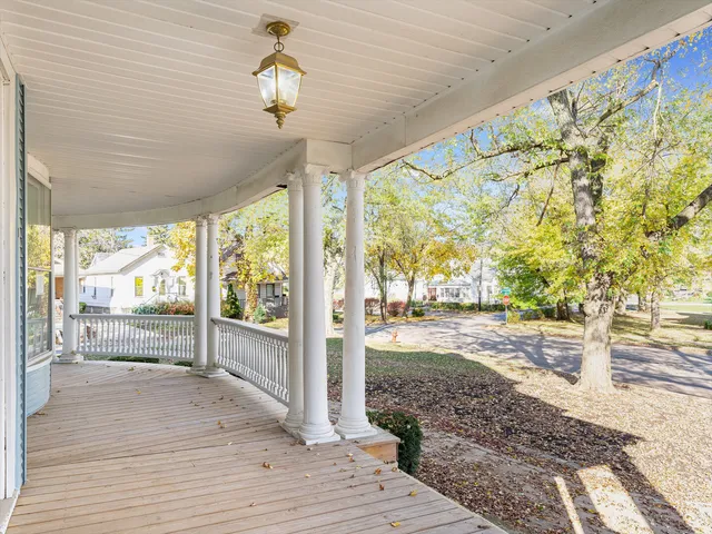 a view of a room with wooden floor and iron stairs