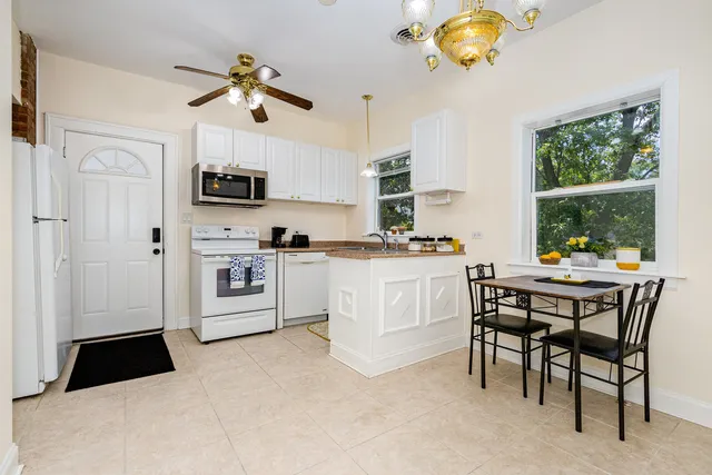 a kitchen with stainless steel appliances kitchen island granite countertop a sink and cabinets