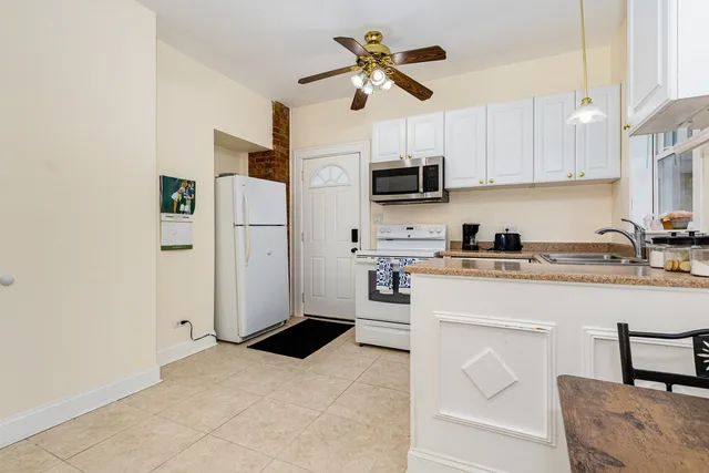 a kitchen with stainless steel appliances a refrigerator sink and microwave