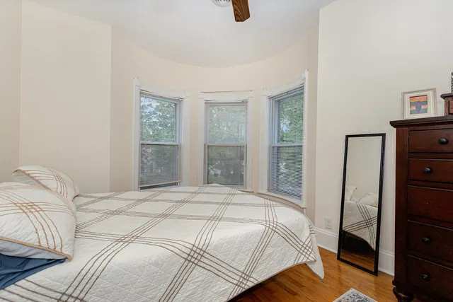 a bedroom with a bed and a dresser