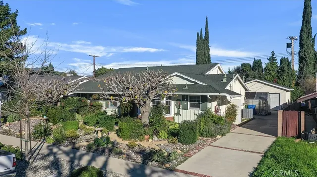 a front view of a house with a garden