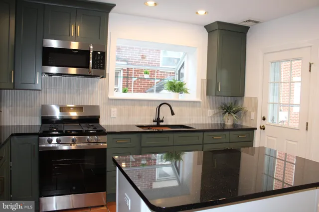 a kitchen with a refrigerator and a sink