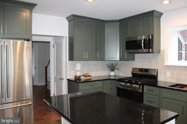 a kitchen with a sink stove and microwave