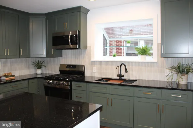 a kitchen with a refrigerator and cabinets
