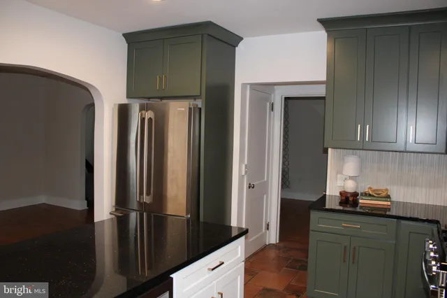 a kitchen with granite countertop a stove and a microwave