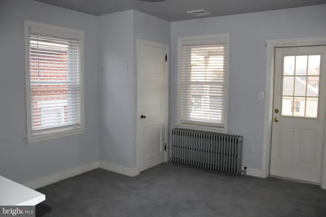 a view of a house with backyard and porch