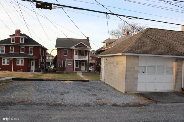 a view of a big house with a garage