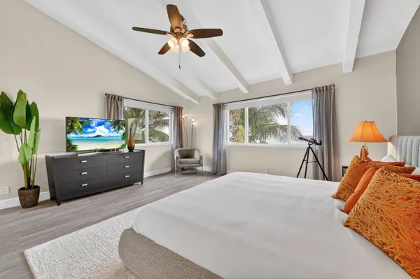 a bedroom with a bed and ceiling fan