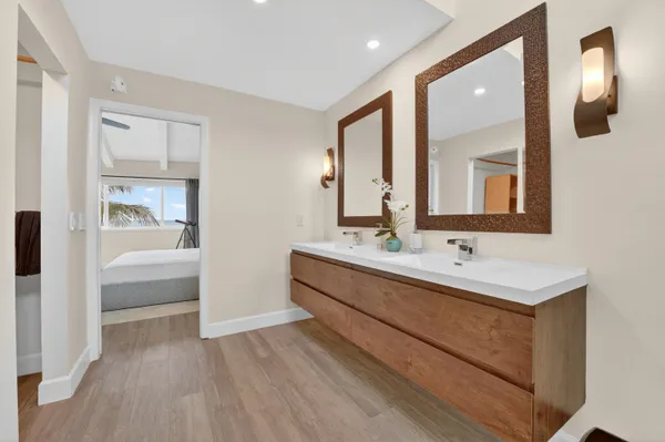a bathroom with double vanity sinks and a mirror
