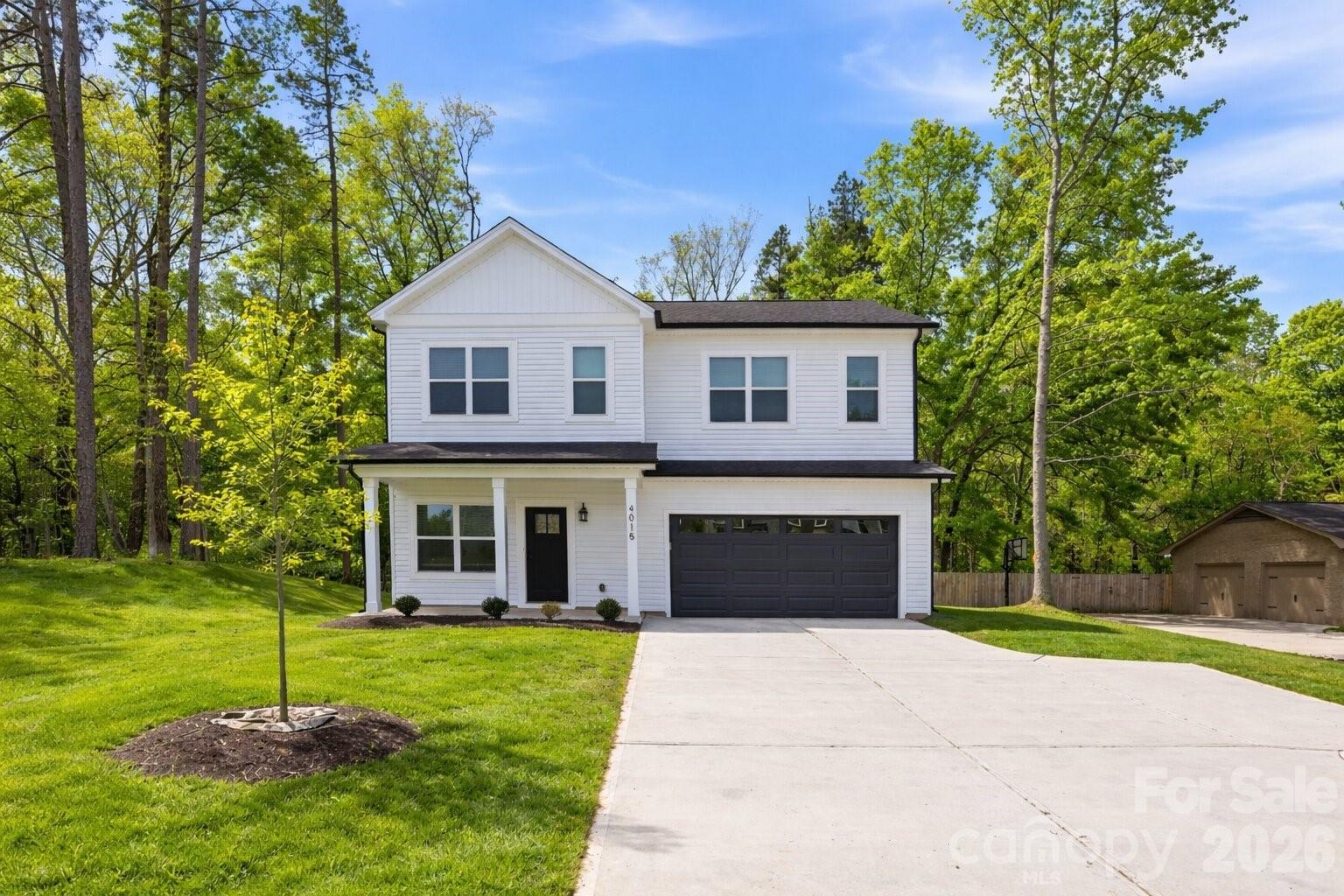 4015 Oakdale Road Charlotte, NC 28216 - Photo 26 of 30 a front view of a house with a yard and trees