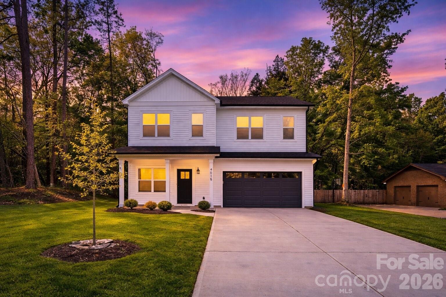 4015 Oakdale Road Charlotte, NC 28216 - Photo 27 of 30 a front view of a house with a yard and garage