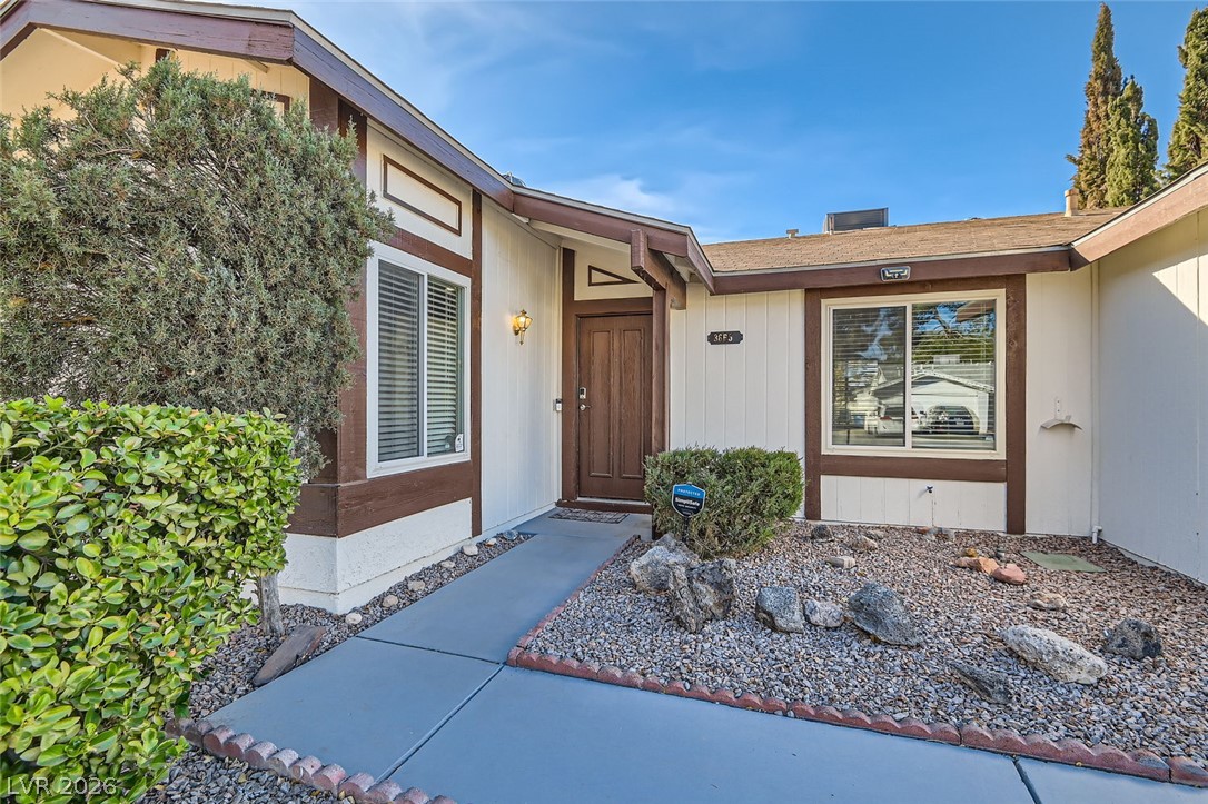 3665 Bronco Road Las Vegas, NV 89103 - Photo 3 of 28 A welcoming entry invites you into this home, framed by desert-friendly landscaping.