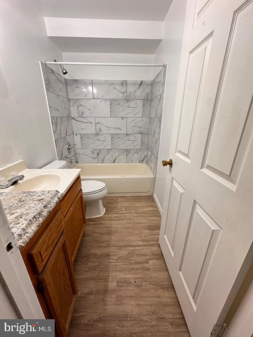 1020 Bennett Place Baltimore, MD 21223 - Photo 3 of 8 a bathroom with a granite countertop sink toilet and shower