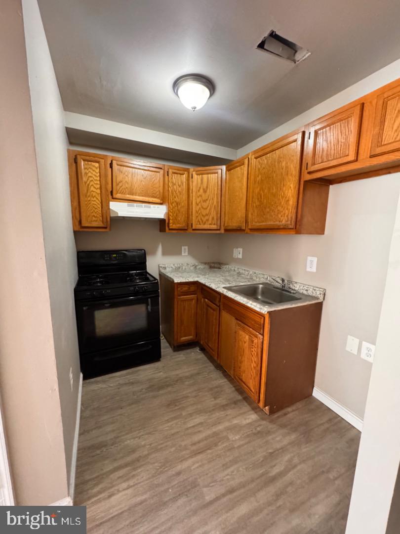 1020 Bennett Place Baltimore, MD 21223 - Photo 6 of 8 a kitchen with stainless steel appliances granite countertop a stove a sink and a refrigerator