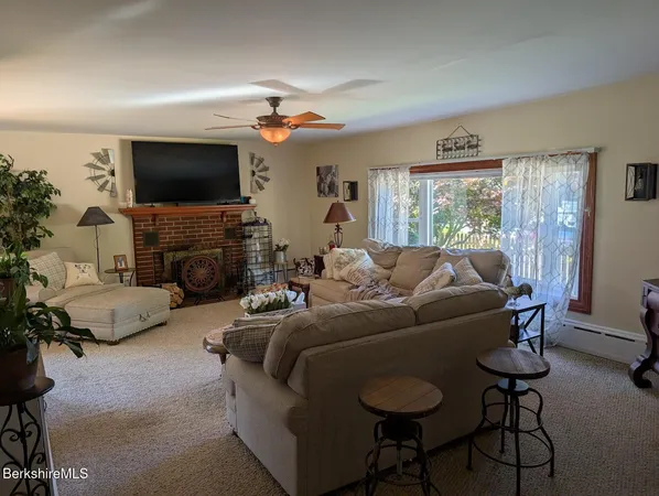 a kitchen with stainless steel appliances granite countertop sink window and chairs