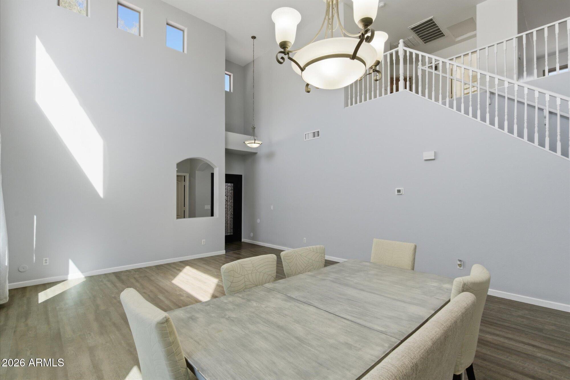 21915 Dietz Drive Maricopa, AZ 85138 - Photo 13 of 31 a bedroom with a bed and a chandelier