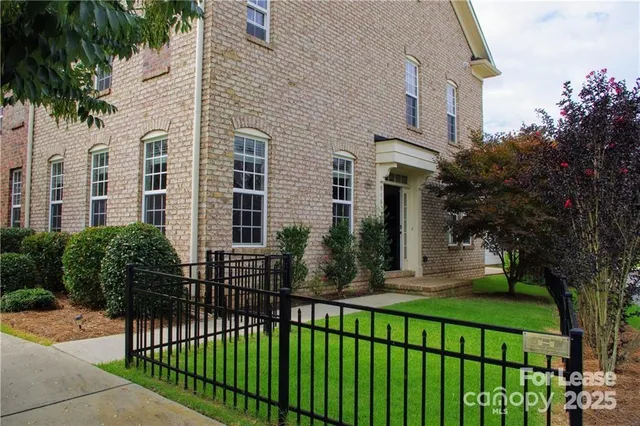 a view of a house with a yard and plants