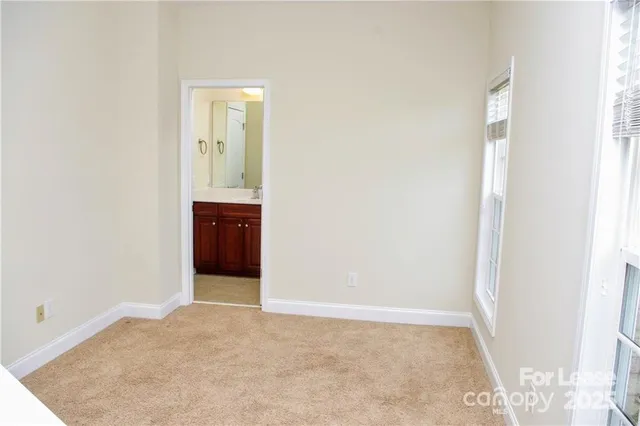 an empty room with closet and mirror