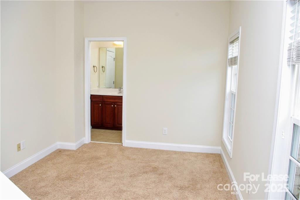 916 Gardners Way Cornelius, NC 28031 - Photo 22 of 35 an empty room with closet and mirror