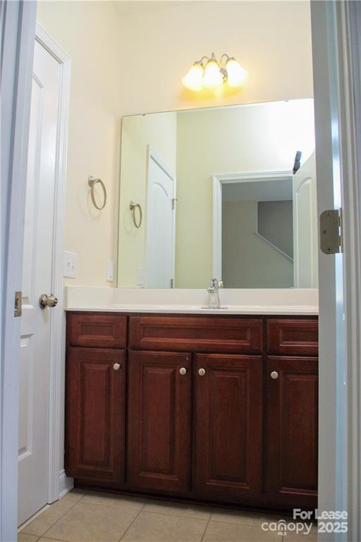 916 Gardners Way Cornelius, NC 28031 - Photo 23 of 35 a bathroom with a granite countertop sink a mirror and a vanity