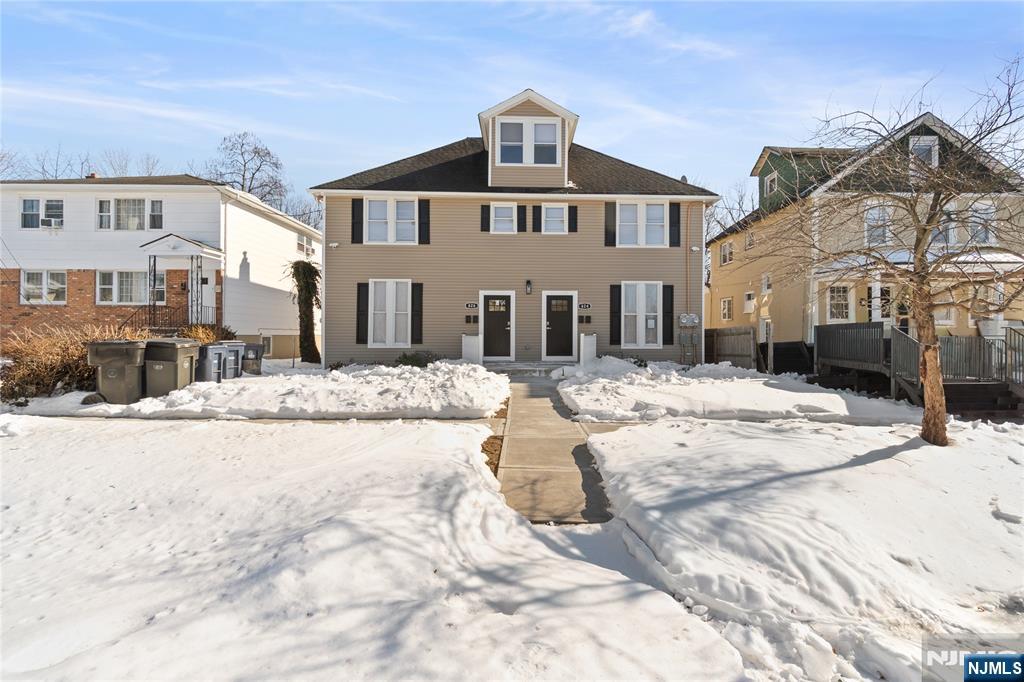 826 George Street, Unit 2 Plainfield, NJ 07062 - Photo 1 of 30 a view of a white house with a yard covered in snow