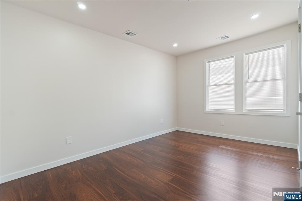826 George Street, Unit 2 Plainfield, NJ 07062 - Photo 12 of 30 an empty room with wooden floor and windows