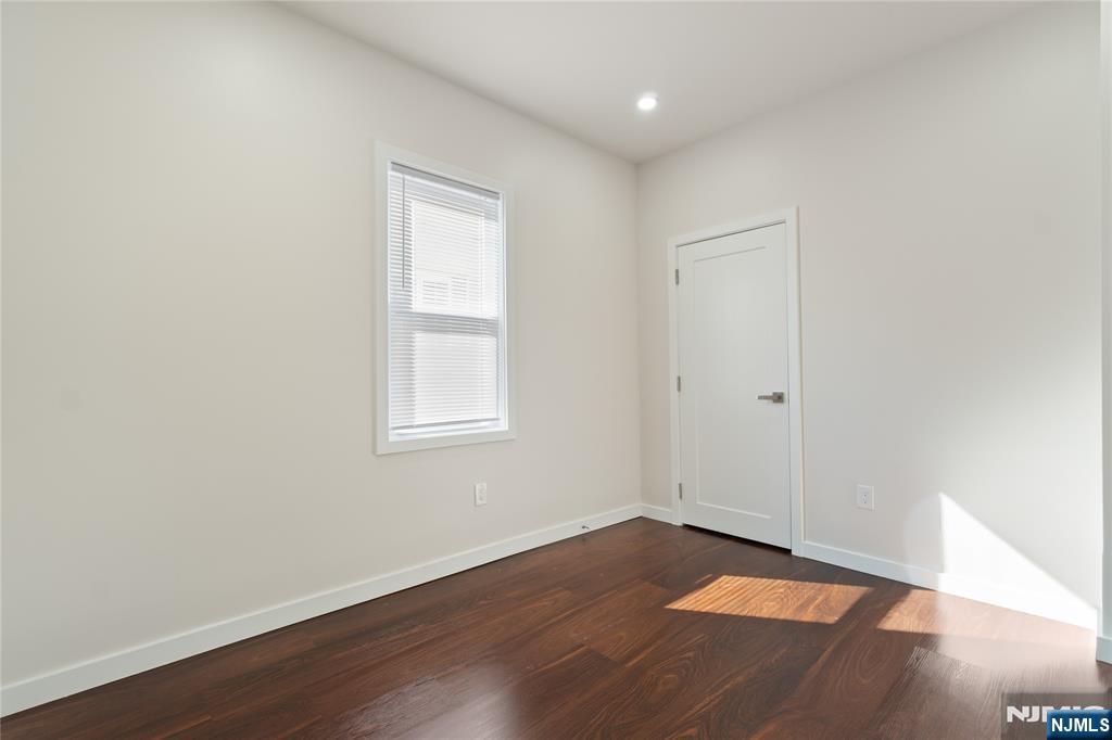 826 George Street, Unit 2 Plainfield, NJ 07062 - Photo 14 of 30 an empty room with wooden floor and windows