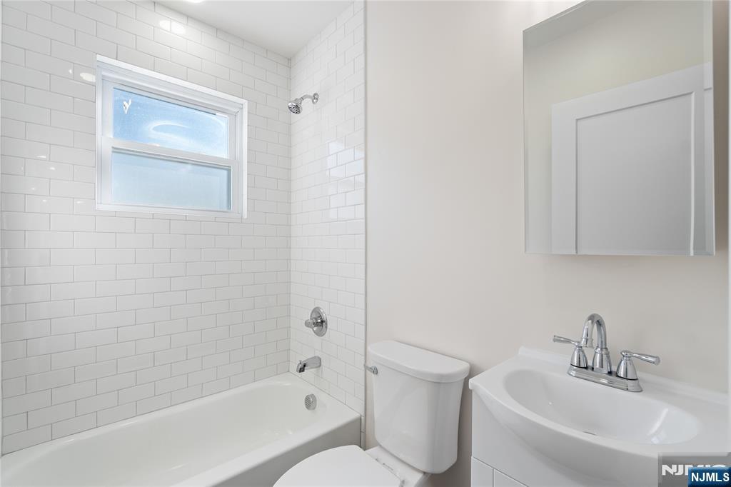 826 George Street, Unit 2 Plainfield, NJ 07062 - Photo 15 of 30 a white bath tub sitting next to a white sink