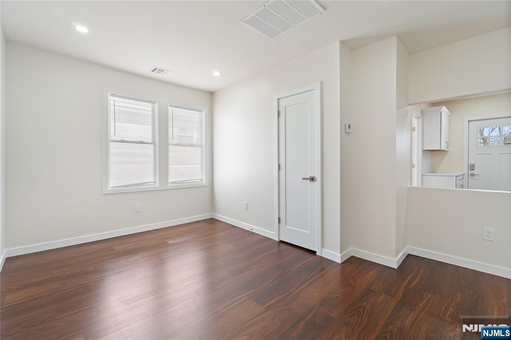 826 George Street, Unit 2 Plainfield, NJ 07062 - Photo 3 of 30 an empty room with wooden floor and windows
