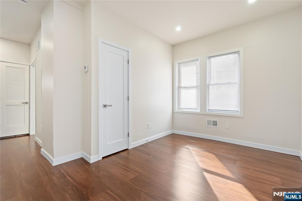 826 George Street, Unit 2 Plainfield, NJ 07062 - Photo 4 of 30 an empty room with wooden floor and windows