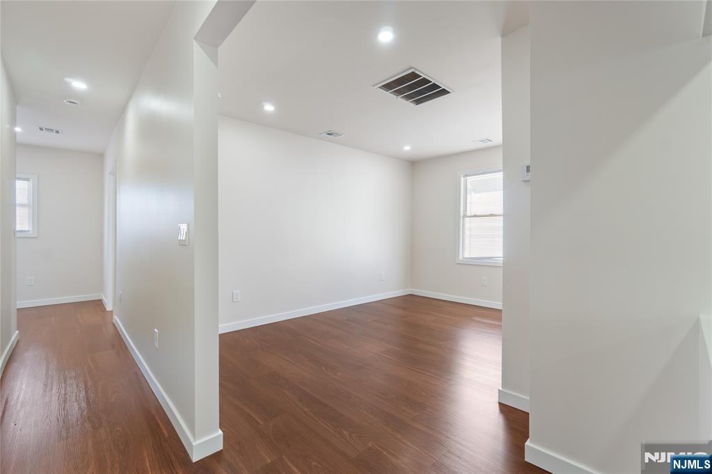 826 George Street, Unit 2 Plainfield, NJ 07062 - Photo 5 of 30 an empty room with wooden floor and windows