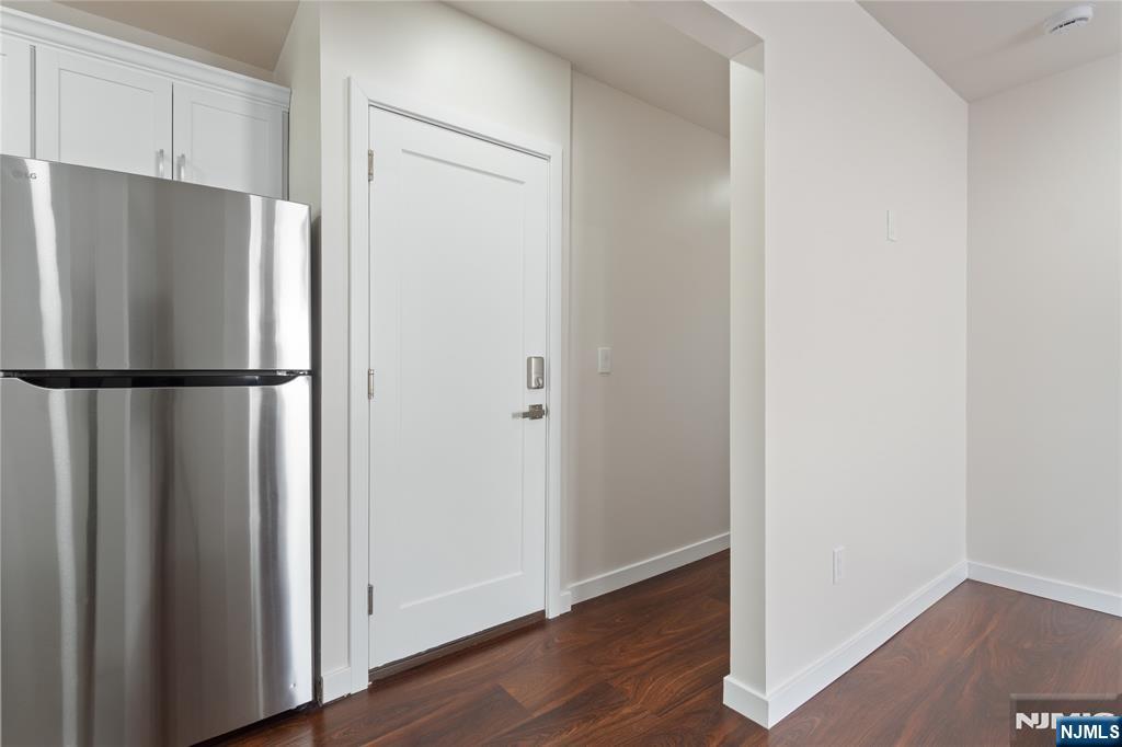 826 George Street, Unit 2 Plainfield, NJ 07062 - Photo 10 of 30 a view of a refrigerator in kitchen and wooden floor