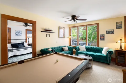 a bedroom with furniture and a large window