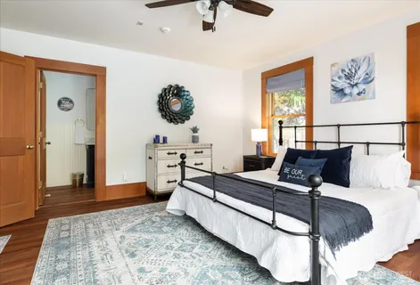a bedroom with a bed and wooden floor