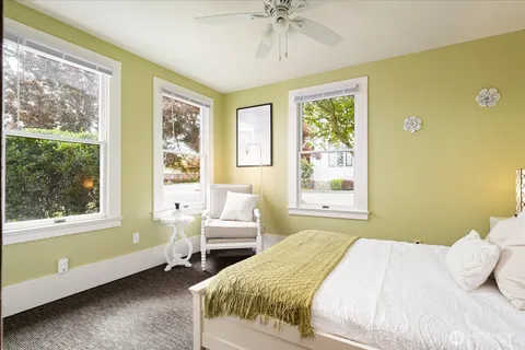a bedroom with a bed and windows