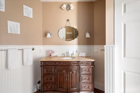 a bathroom with a sink vanity and a mirror