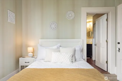 a bedroom with a bed and a lamp on table