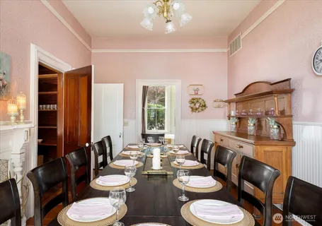 a dining room with furniture a rug and wooden floor