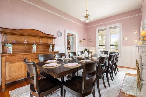 a view of a dining room with furniture and wooden floor