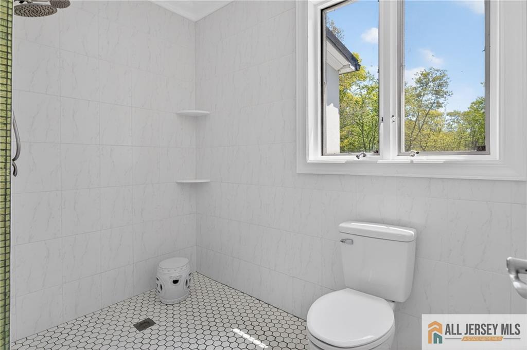 381 Monmouth Road Freehold, NJ 07728 - Photo 52 of 63 a white toilet sitting next to a window