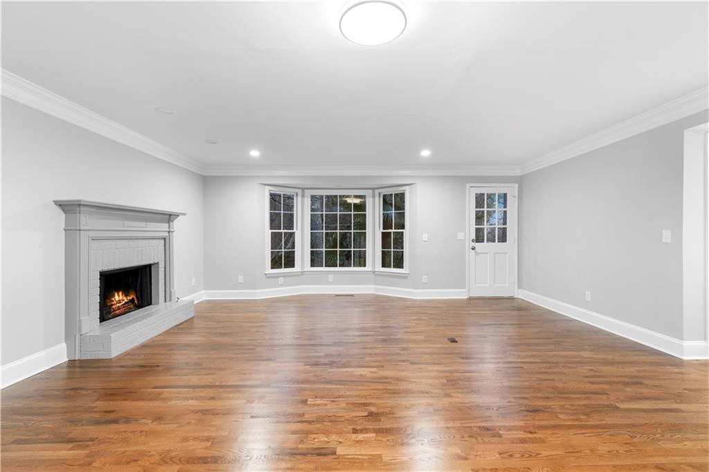 3907 Brinton Mill Road Marietta, GA 30062 - Photo 11 of 61 a view of empty room with wooden floor and fireplace